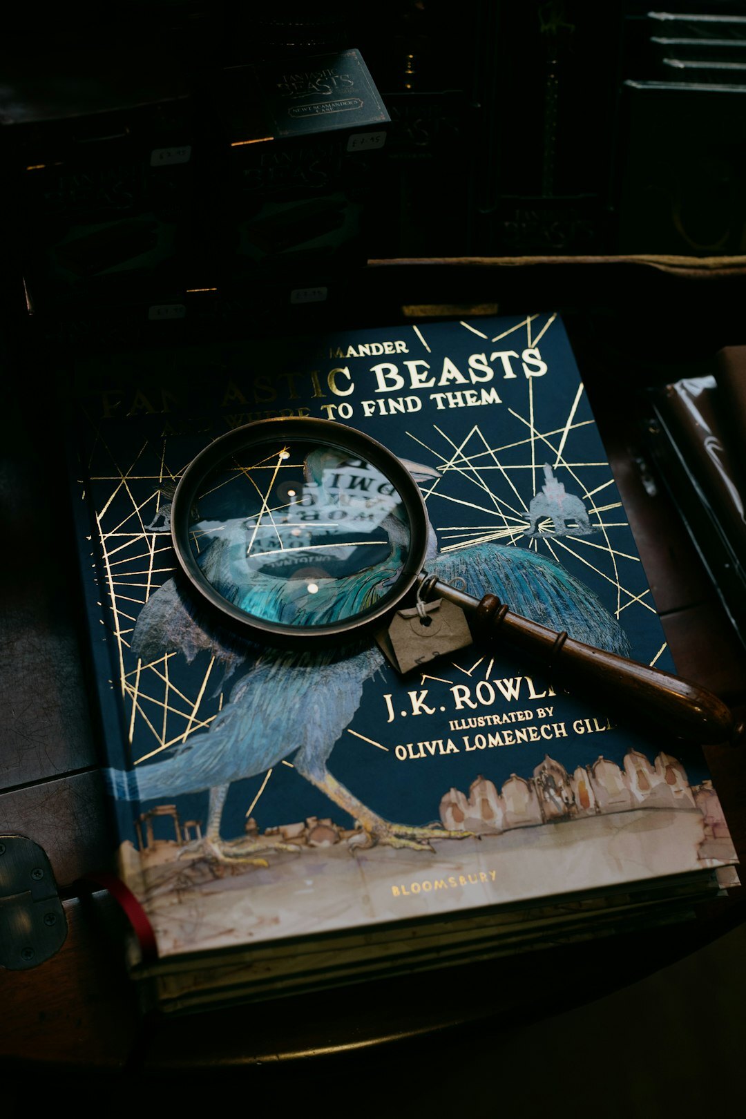 Stack of vintage mystery novels with a magnifying glass on top