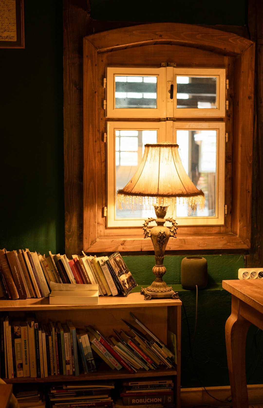 Cozy writer's study with bookshelves and warm lamp light