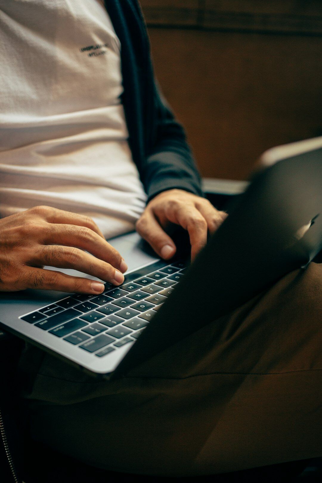 writer typing on laptop