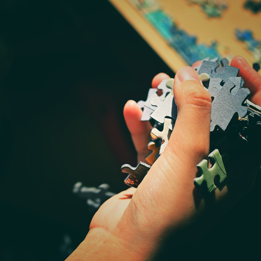person solving jigsaw puzzle
