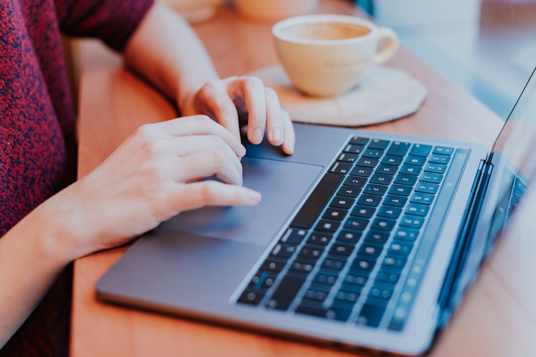 writer typing on laptop